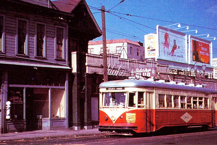 Electric rail transit in 1950 featuring a red and white trolley car