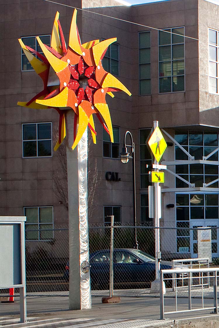 Civic Drive Iris sculpture is a red pinwheel on a tall metal stand