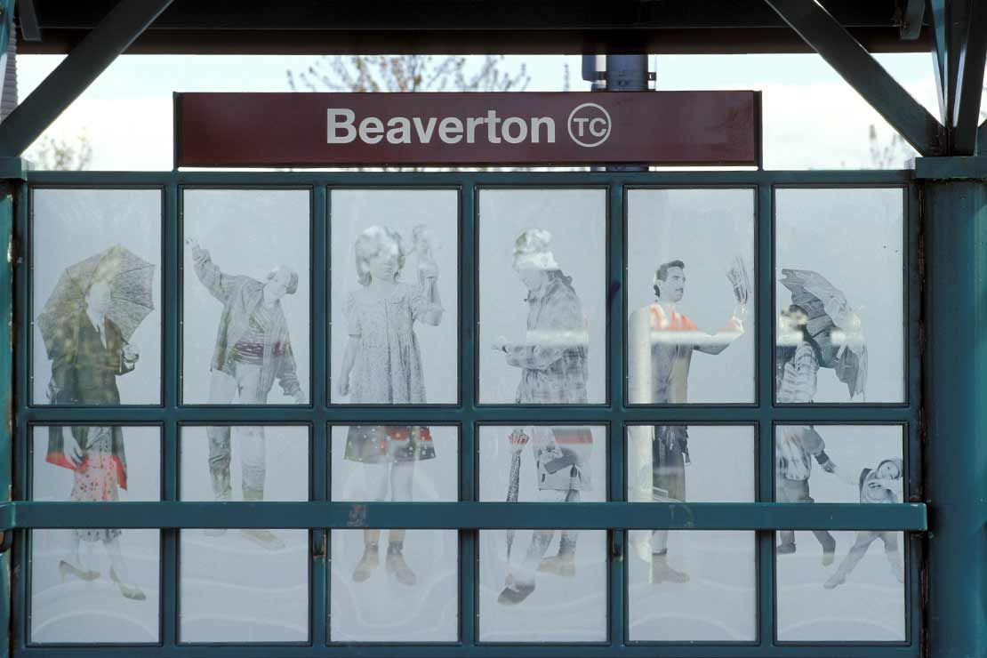 Windscreen glass in a green metal grid etched with images of people in the background