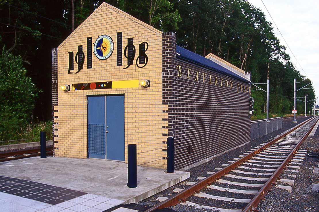 Systems building with '1998' in large numbers above a bright blue door