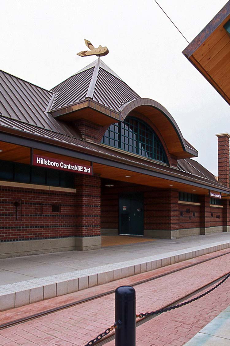 Hillsboro Central building is red brick next to red brick light rail tracks