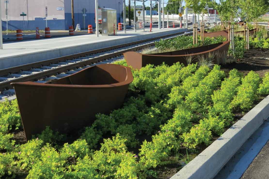 'Passage' - large scuplted metal canoes in a plated median next to the MAX tracks