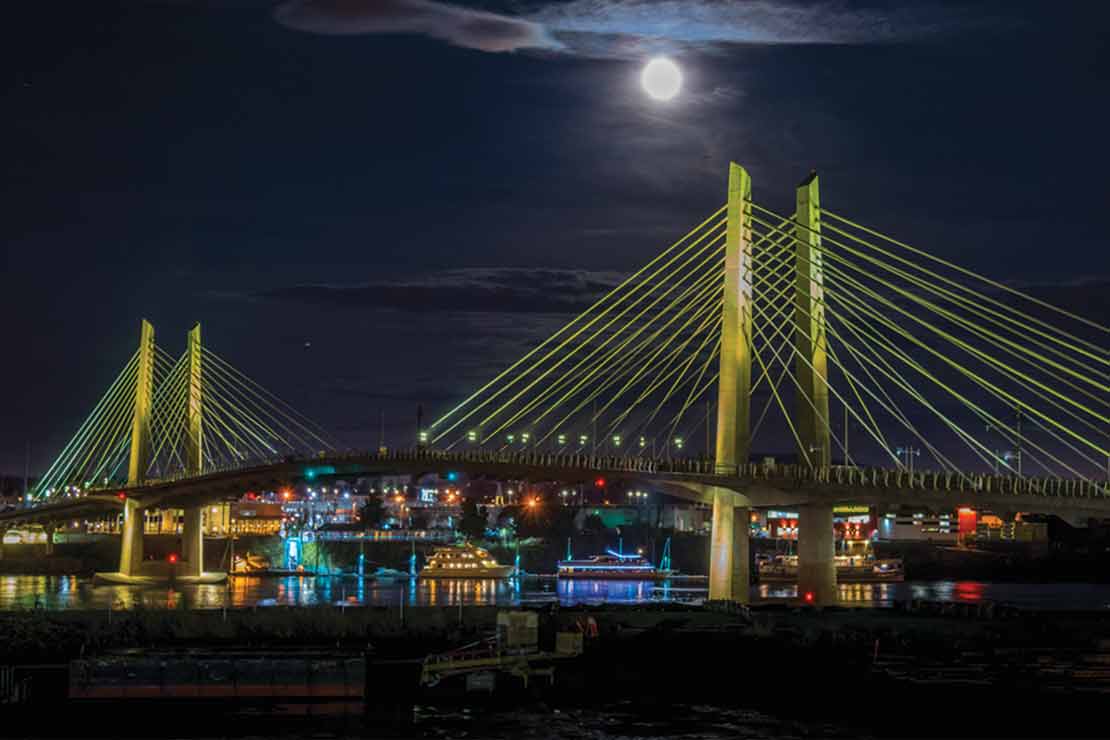 Tilikum Bridge Lights refelcting in the river under a full moon