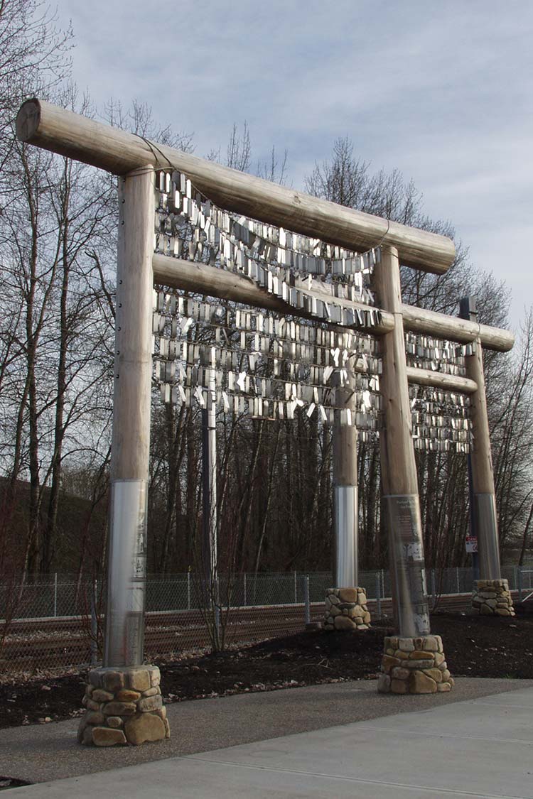 Voices of Remembrance - metal gateway sculpture with metalic fringe hanging on it